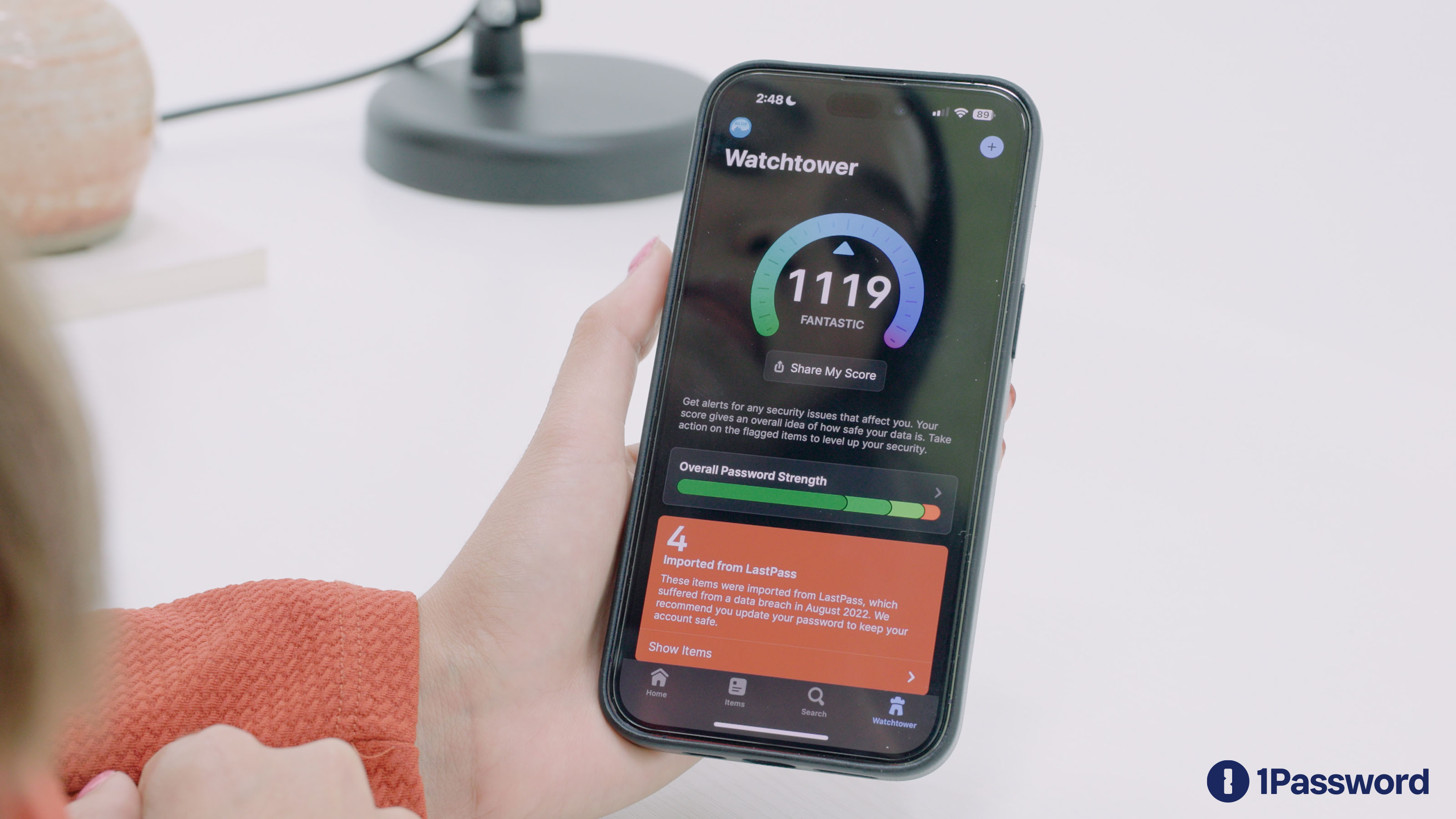 1Password Watchtower showing a security score and breach alerts on iPhone